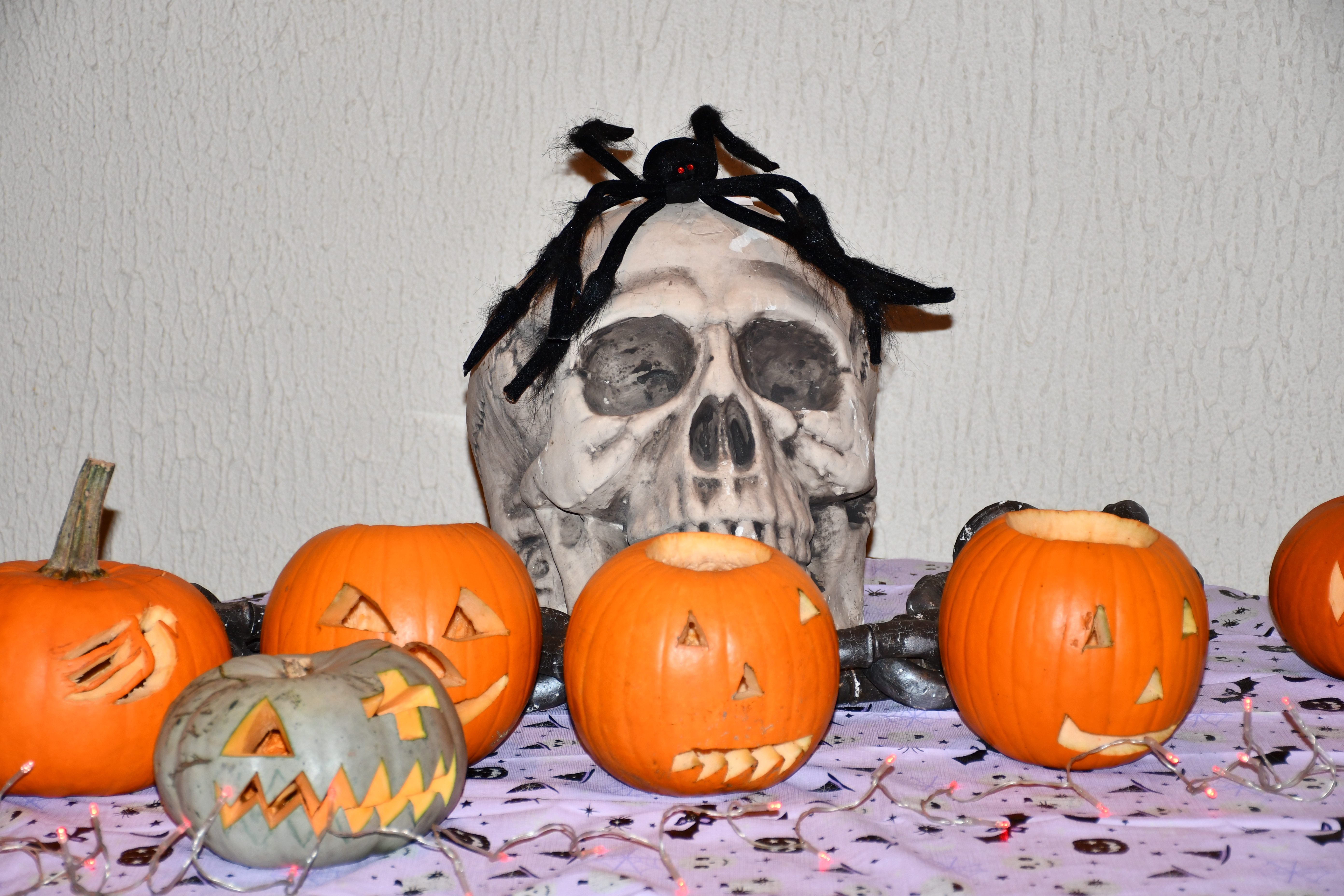 A Halloween skull and some carved pumpkins.