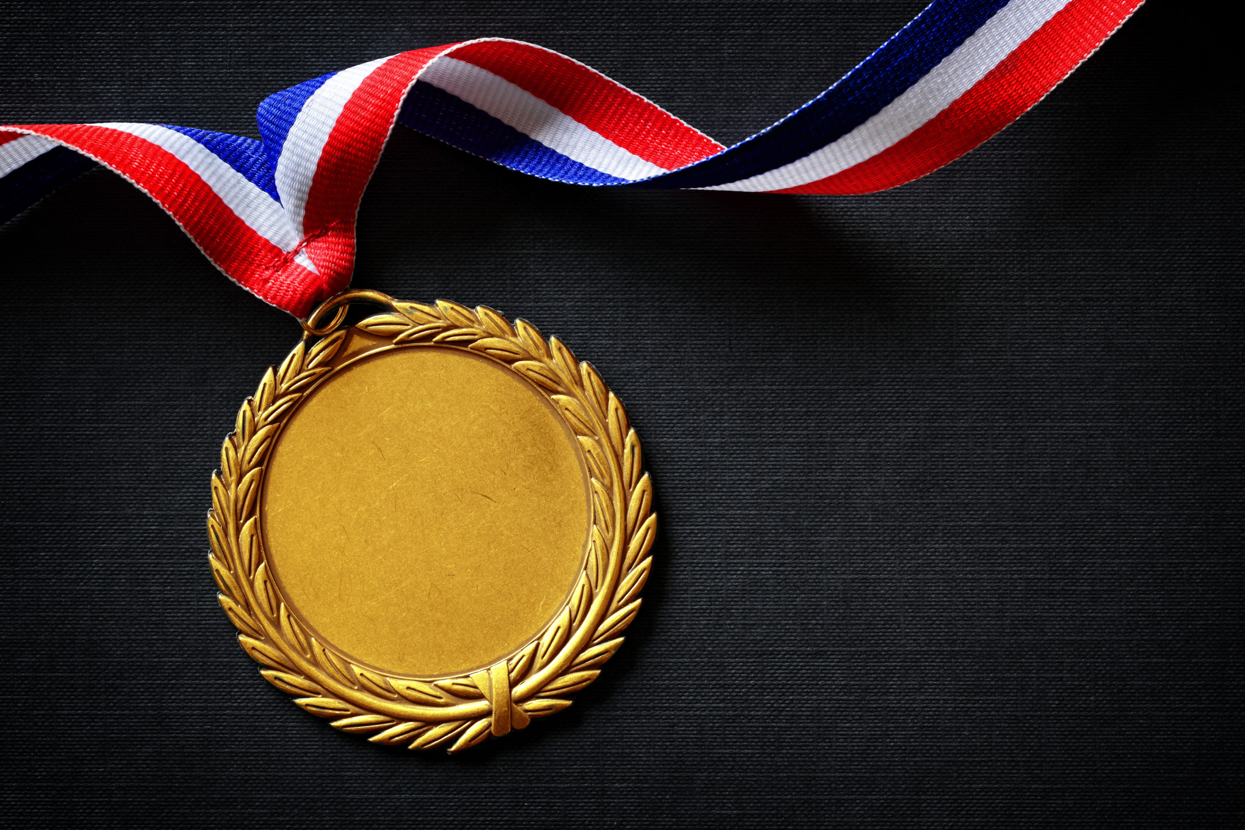 A gold medal on a black background