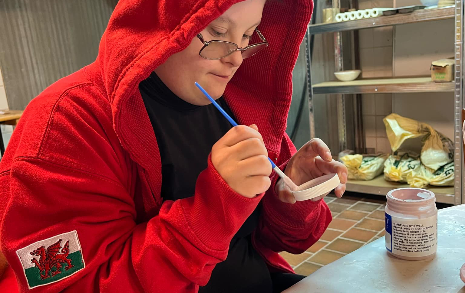 Learner painting pottery.