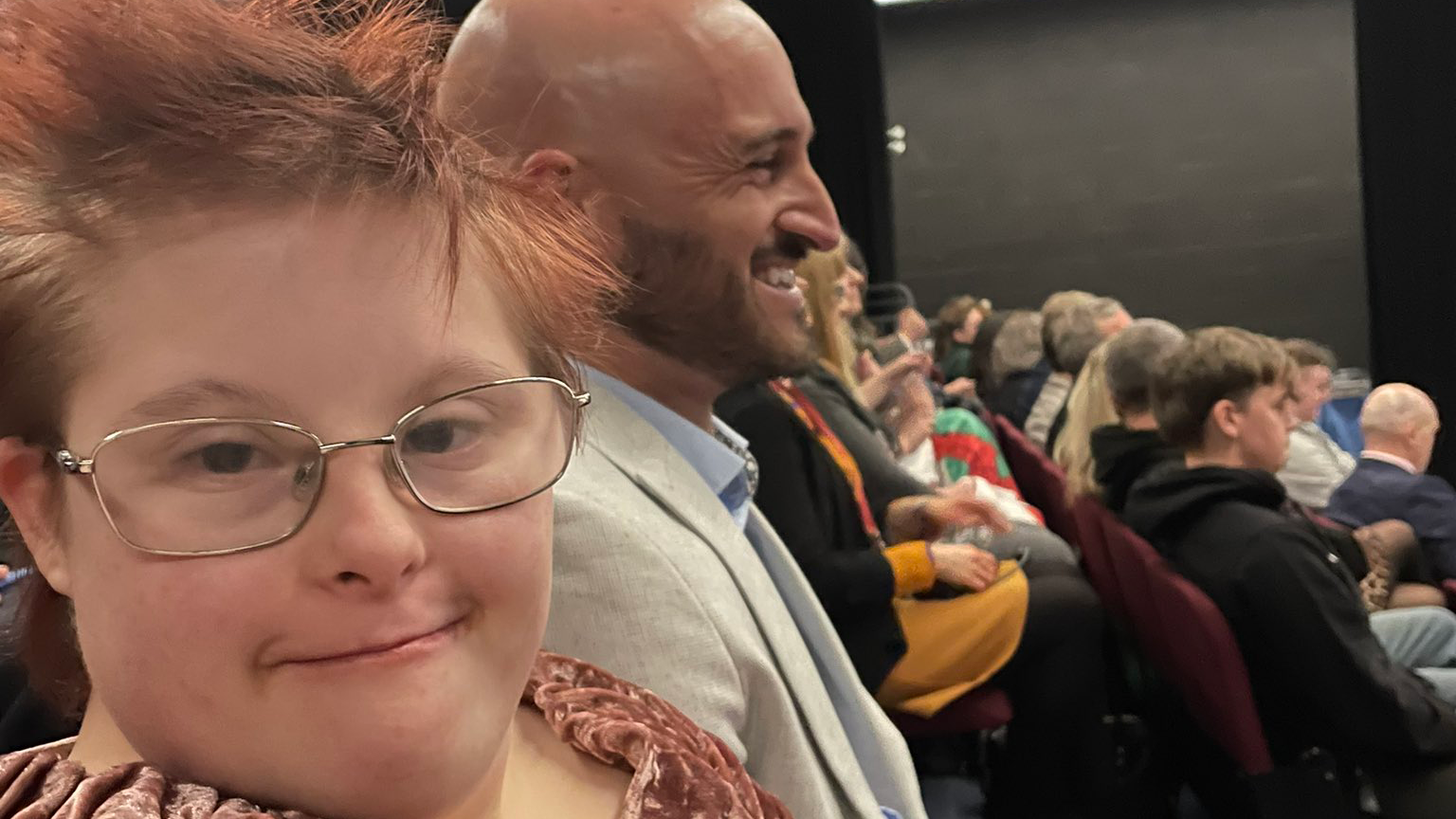 Ellie and Geraint in the audience at an awards ceremony.