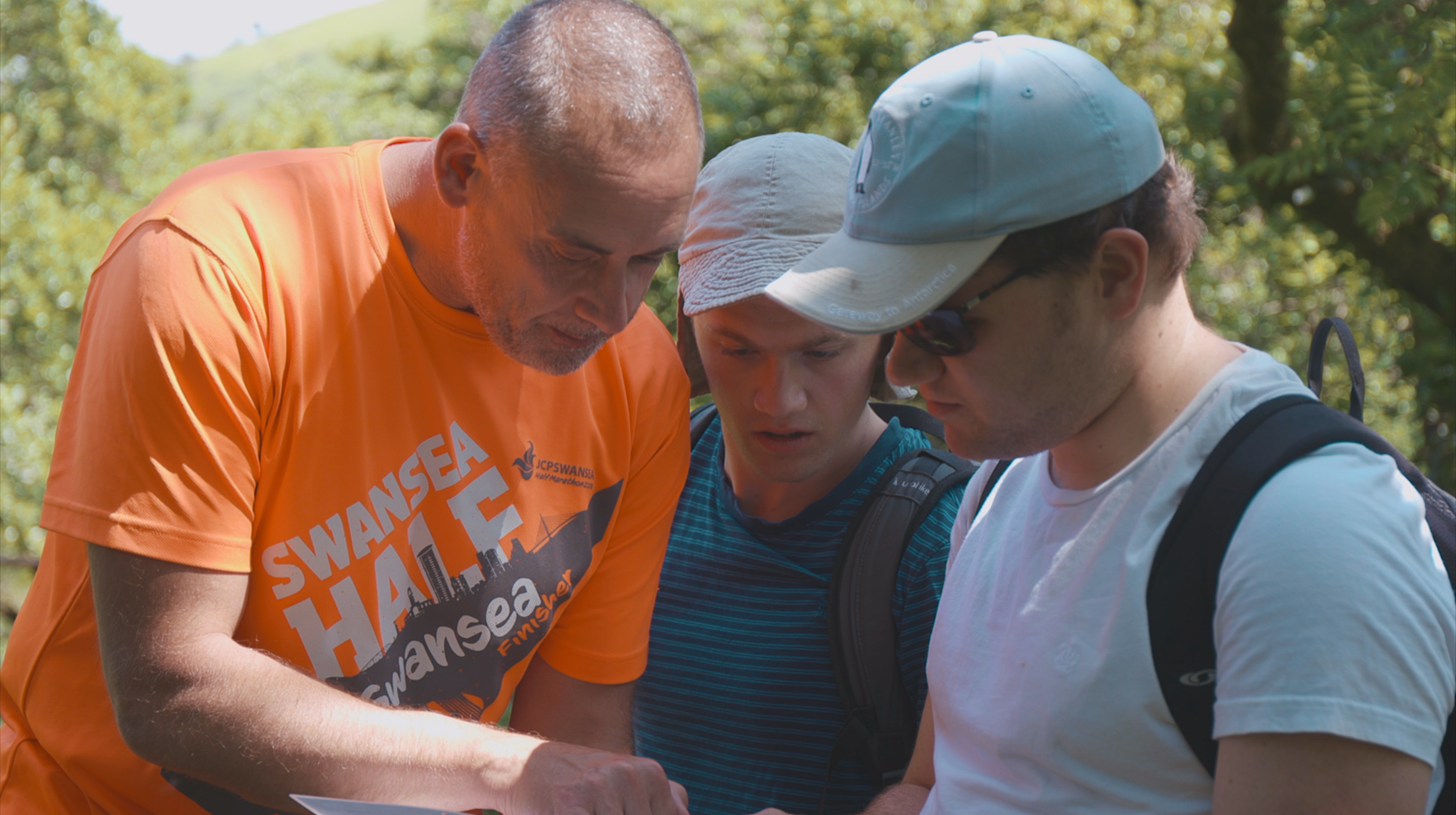 Man and boys reading a map on Elidyr Communities DofE