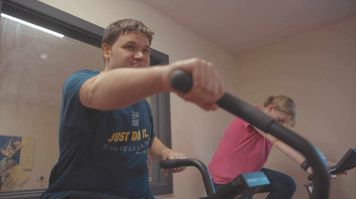 Boy on an exercise bike.