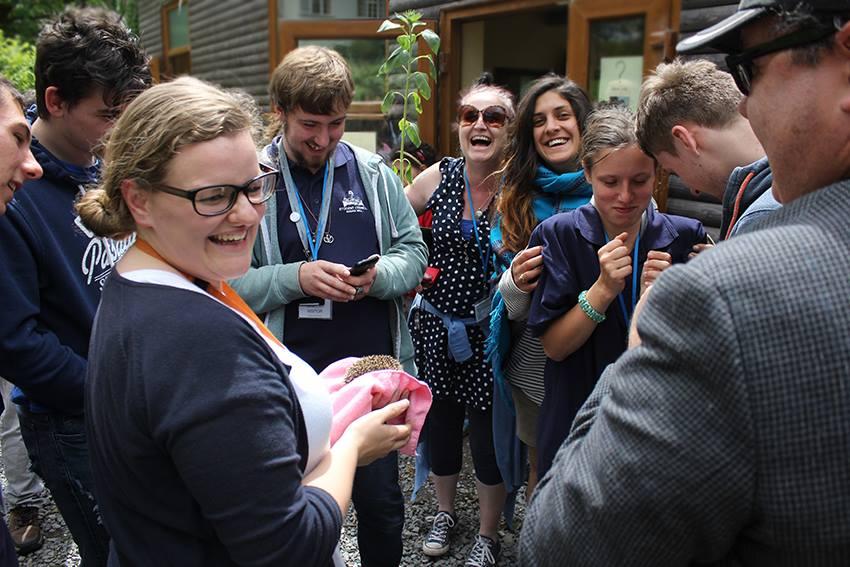 Volunteer and staff with a a hedgehog.