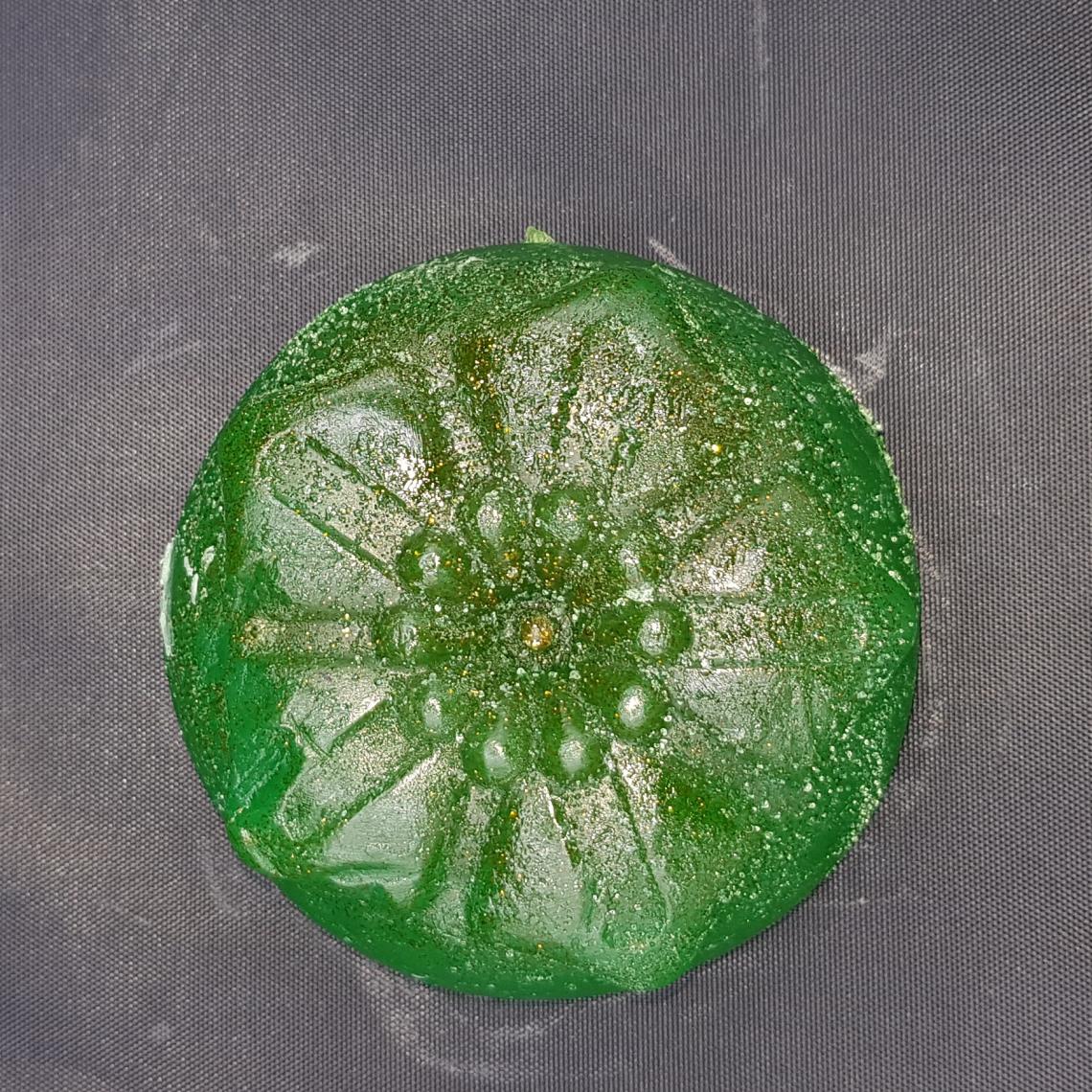 Circle green flower soap with glitter.