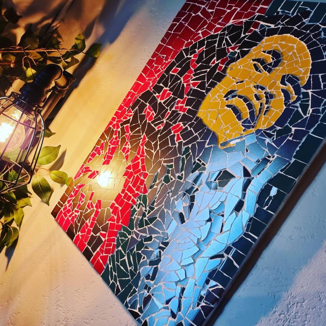Bob Marley mosaic on a wall.