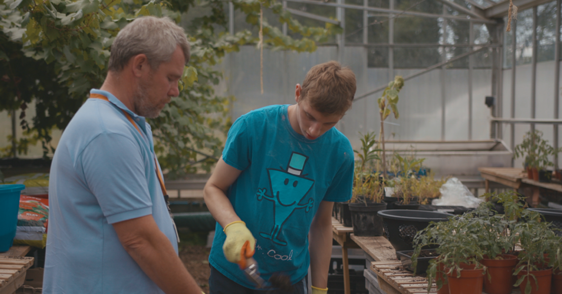 Man and boy in greenhouse at Elidyr Communities Trust