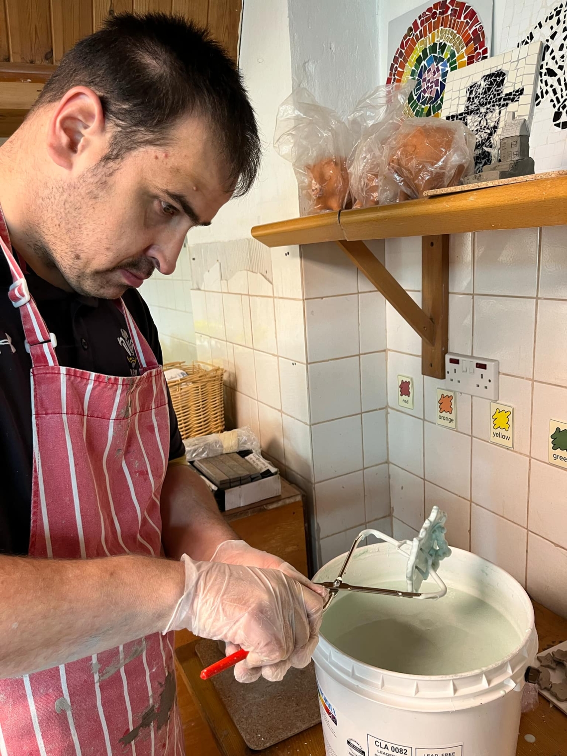 Learner painting pottery.