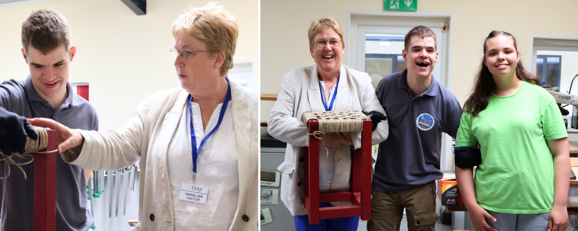 A young man shows an older woman a stool. An older woman and 2 young adults laugh and hold up a stool