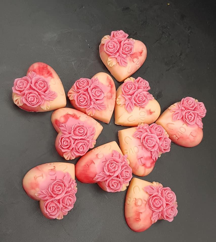 Heart shaped soaps with rosed carved on them.