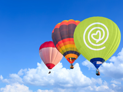 Three hot air balloon - the first is green with a logo on