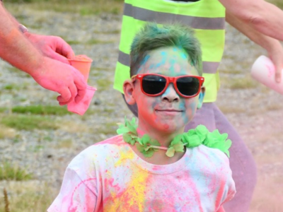 A boy in red sunglasses at a Colour Run