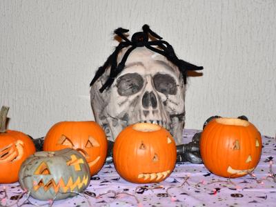 A Halloween skull and some carved pumpkins.