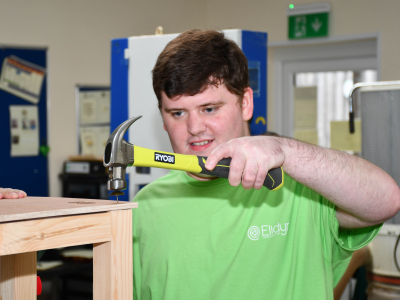 Learner using a hammer