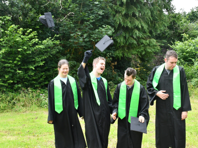 Graduates throwing their mortar boards