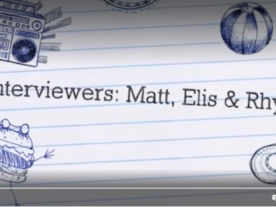 A still from a film clip. A lined piece of paper with: Interviewers: Matt, Elis & Rhys typed on it