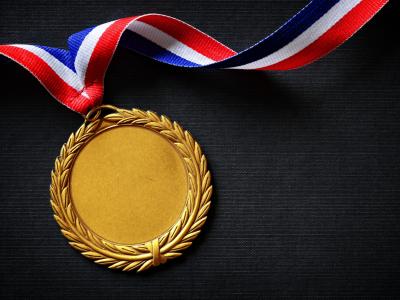 A gold medal on a black background