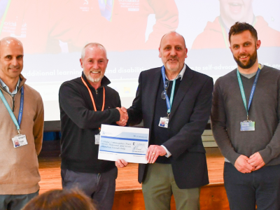 A group of people and a chequer presentation 