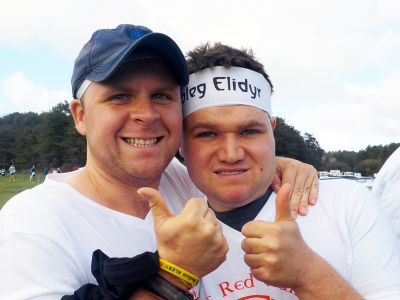 Two boys with their thumbs up with Elidyr Community Trust headbands