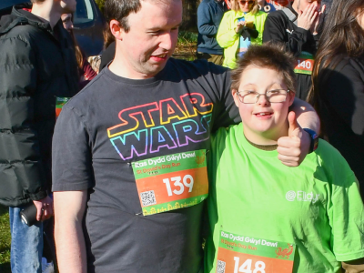 A young man and woman race for Elidyr Communities