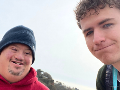 Two men smile at the camera